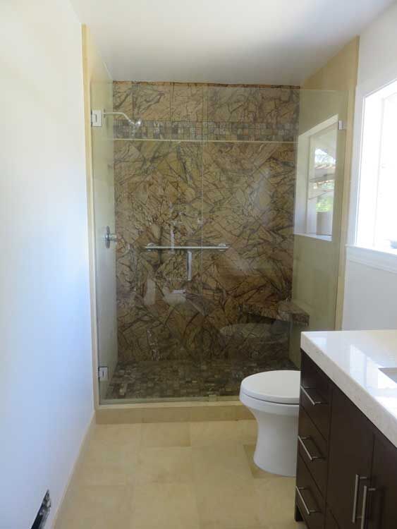 Bathtub surround with natural stone tile by Miconi Marble & Tile