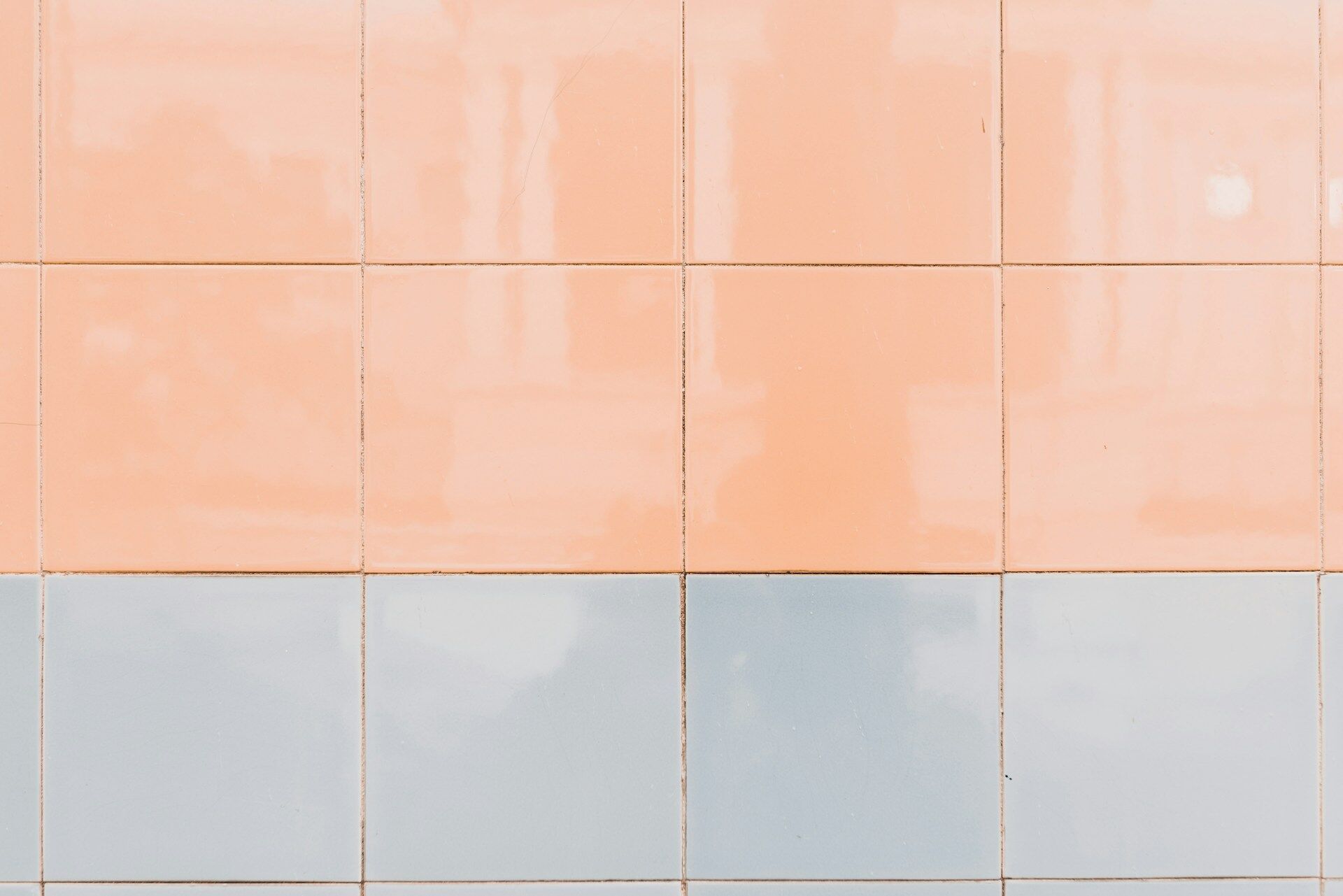 Ceramic tiles in peach and light blue arranged in a grid pattern