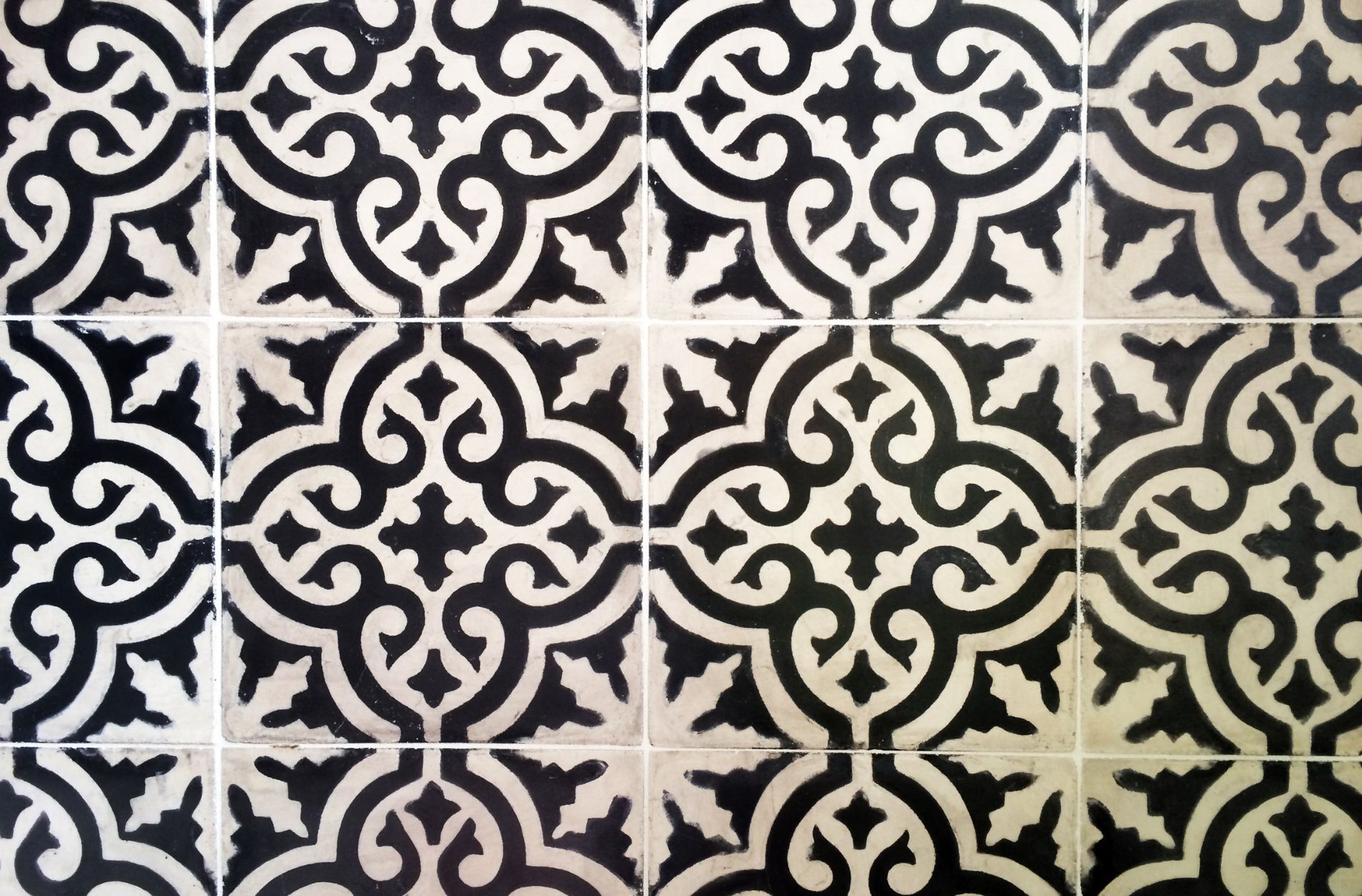Close-up of black and white encaustic cement tiles with geometric design