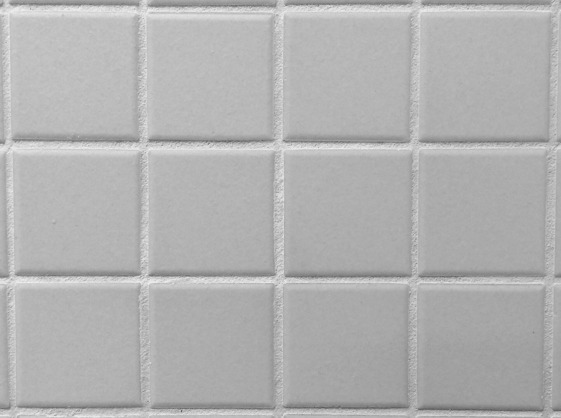 Close-up view of square tiles with visible grout lines in a grid pattern