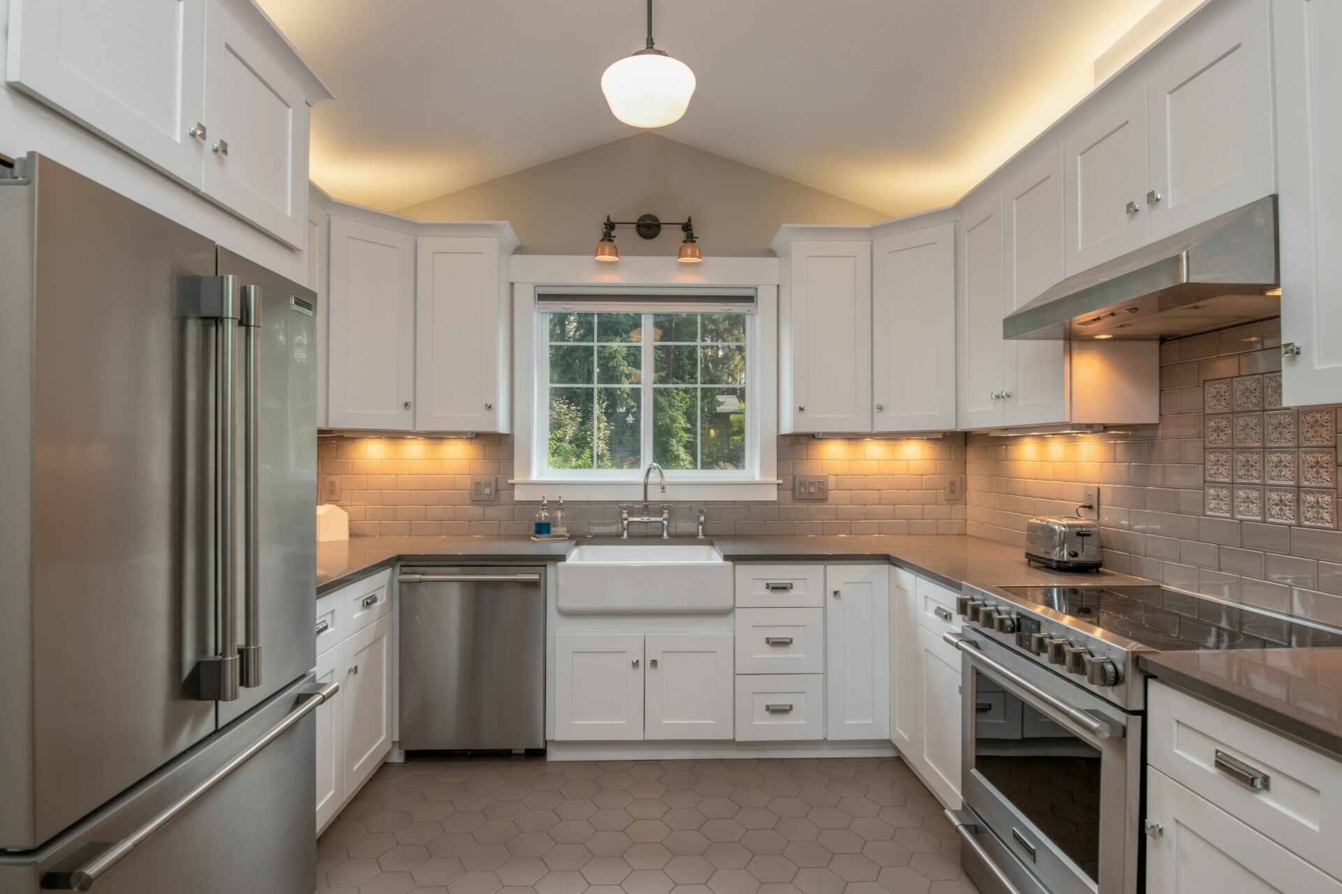 Modern kitchen with white cabinets, stainless steel appliances, and subway tile backsplash