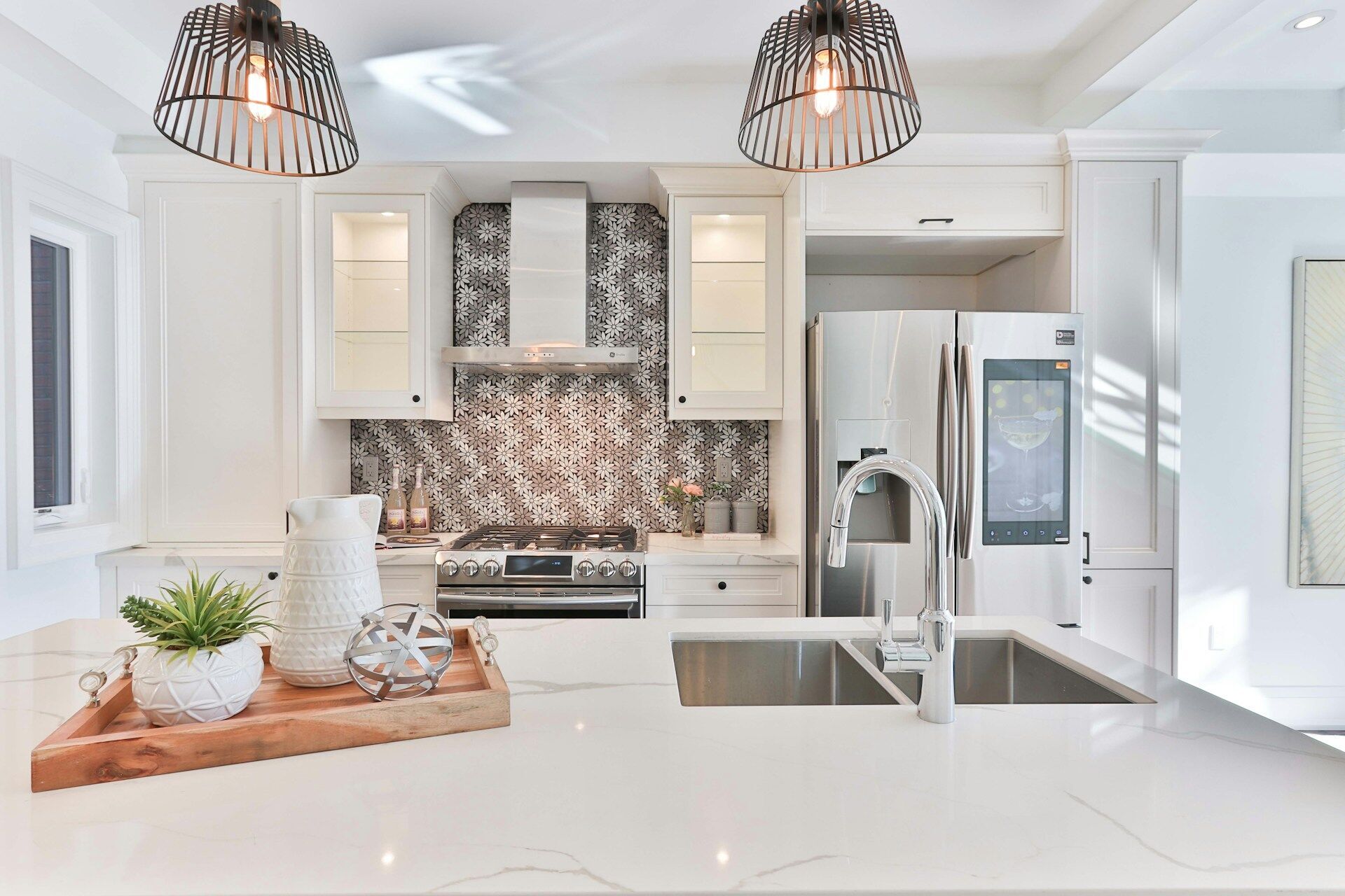 Modern kitchen with marble countertop, double sink, and stainless steel appliances