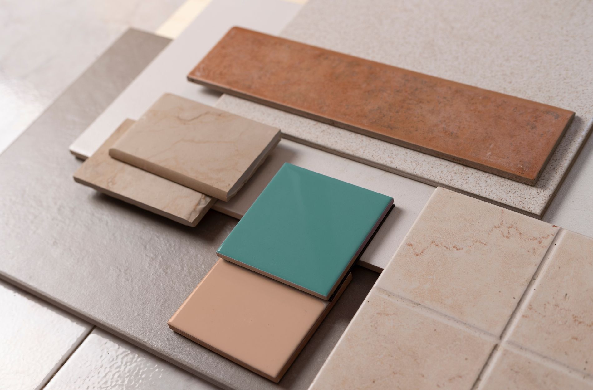 Assorted tiles in various colors and textures arranged for pairing ideas