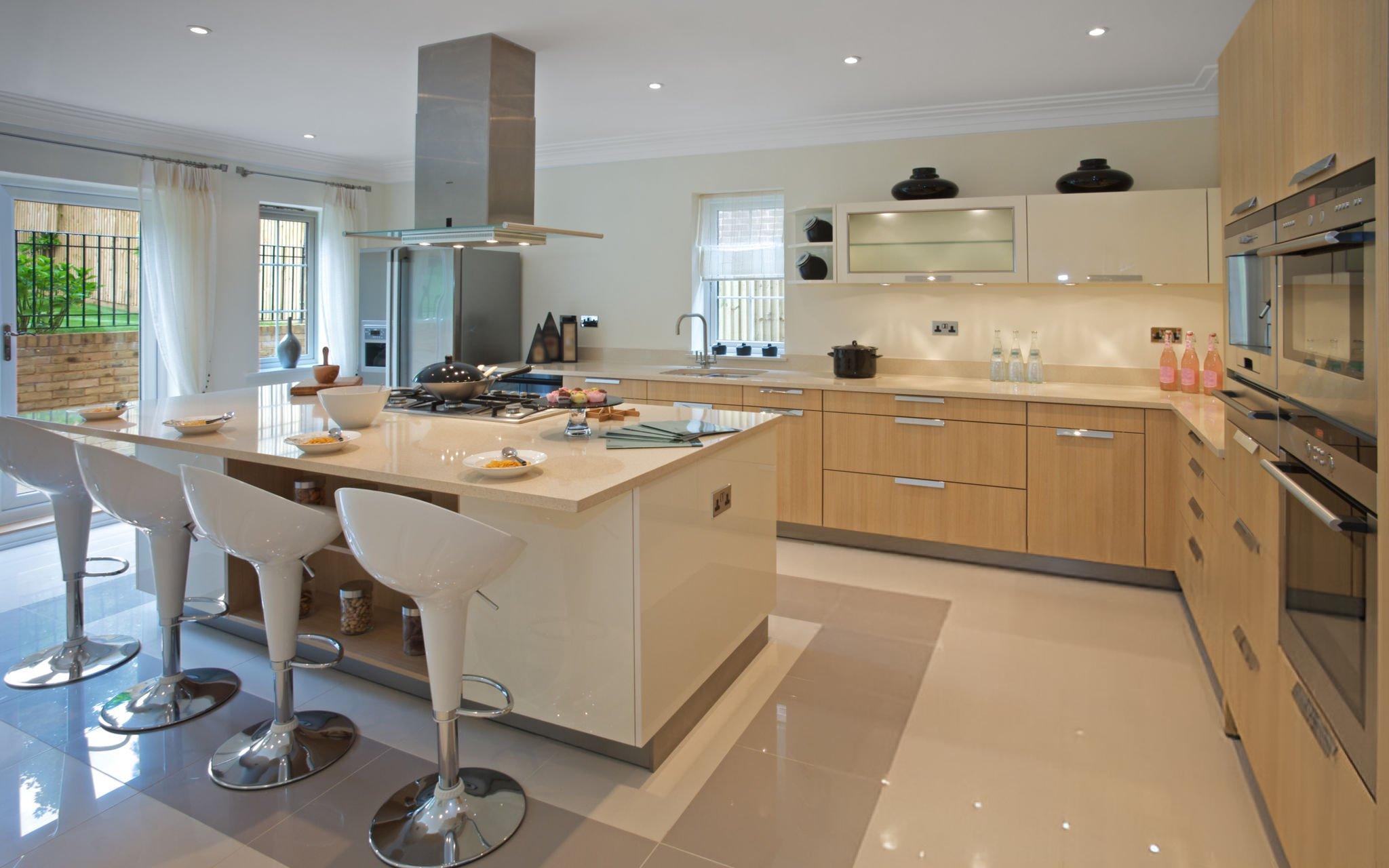 Modern kitchen with ceramic tile countertop, bar stools, and wooden cabinets