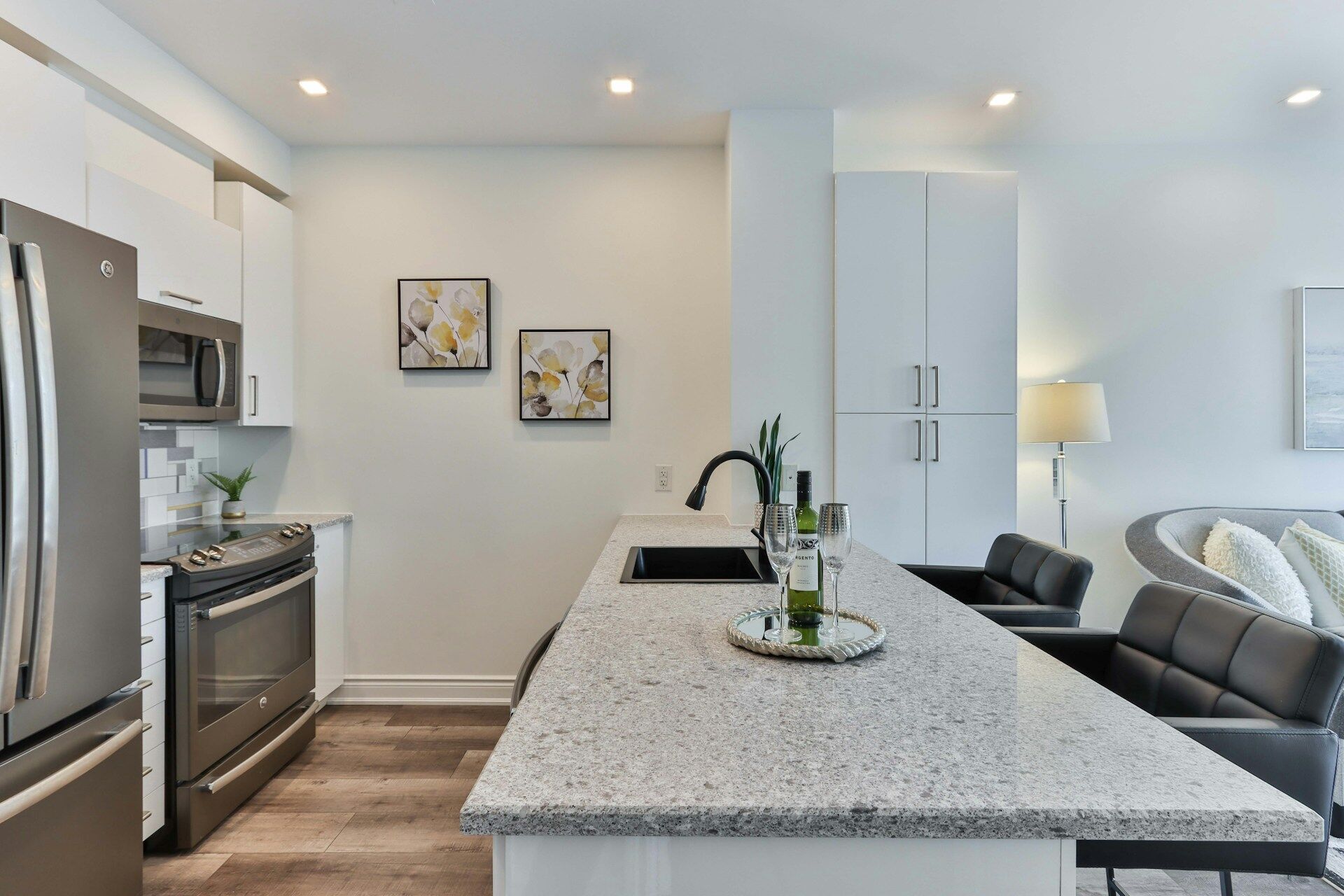 Modern kitchen featuring a granite countertop island and stainless steel appliances