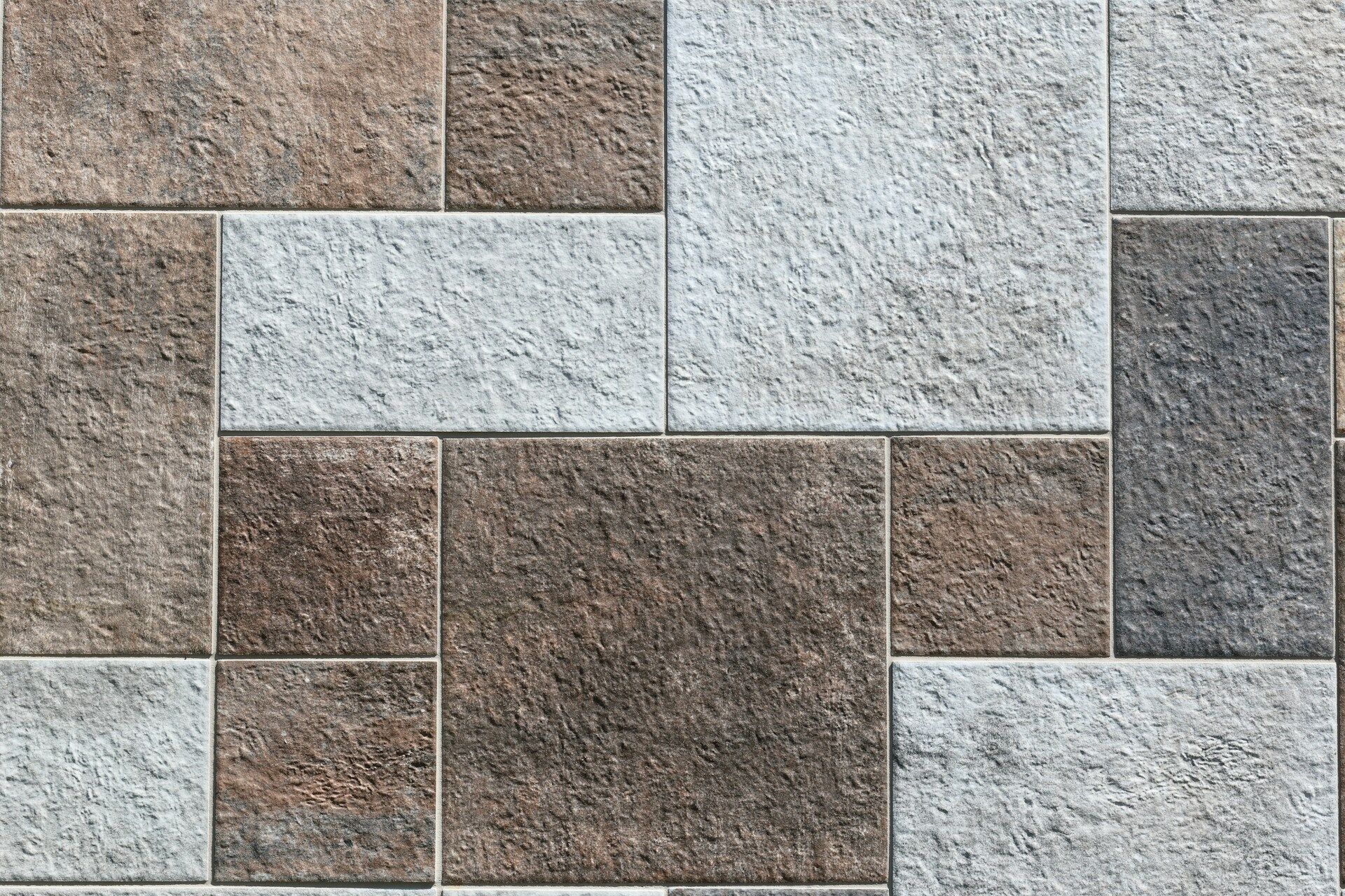Close-up of textured rectangular tiles in brown and gray shades, showcasing a sustainable design