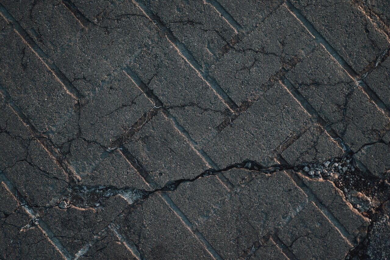 Close-up of a cracked tile floor showing visible fractures and lines