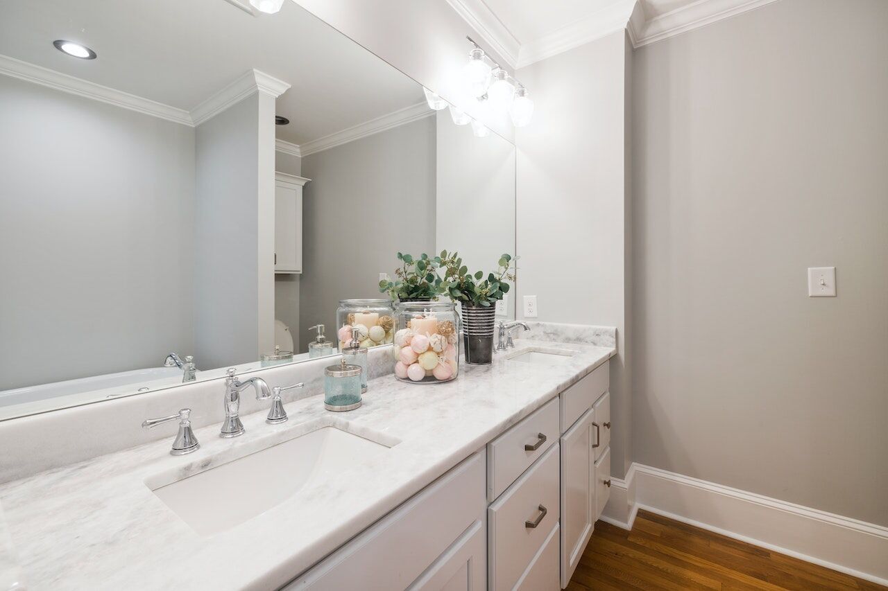 Modern bathroom with white marble countertop, dual sinks, and chrome faucets
