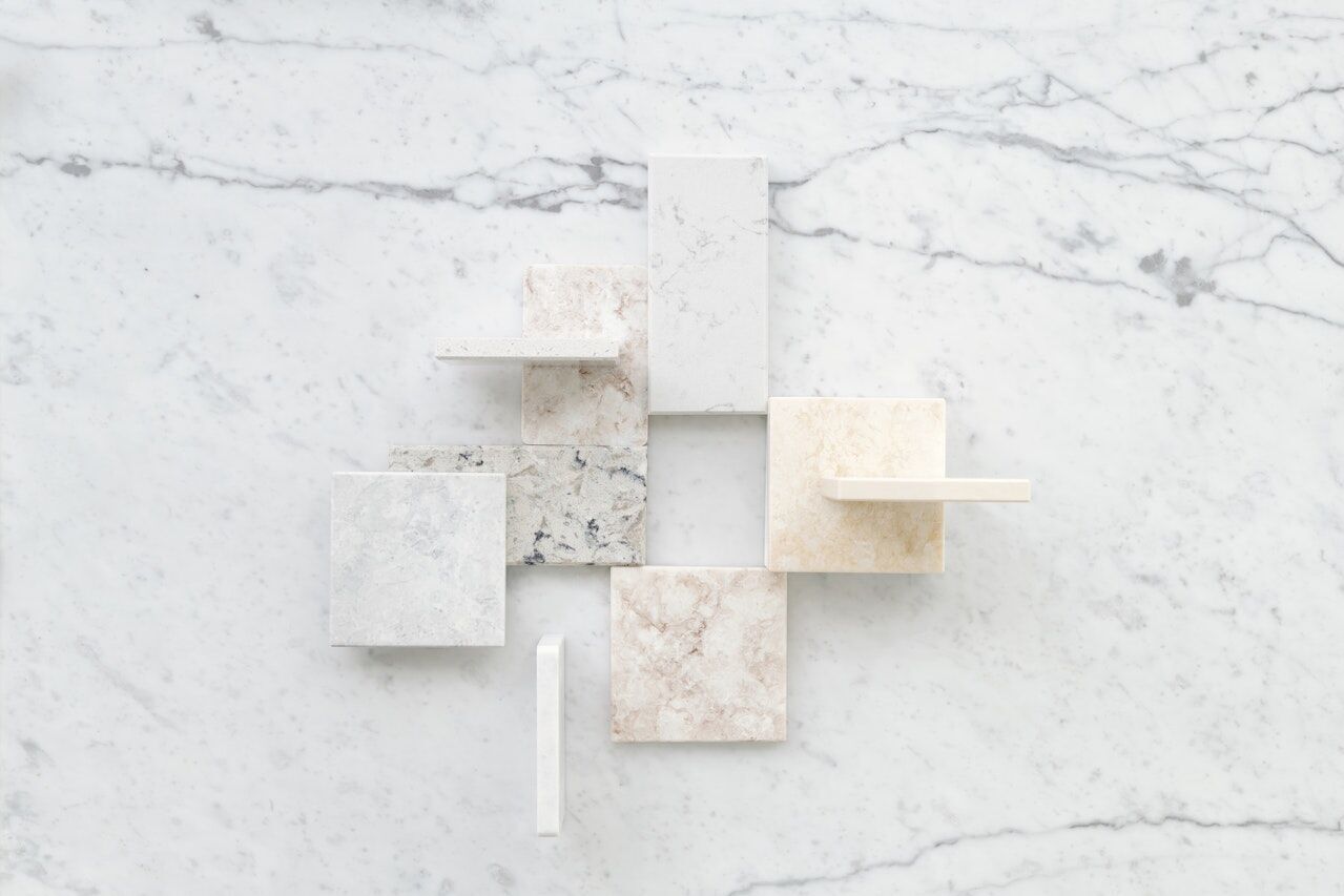 Assorted marble samples in different colors and textures on a marble slab background