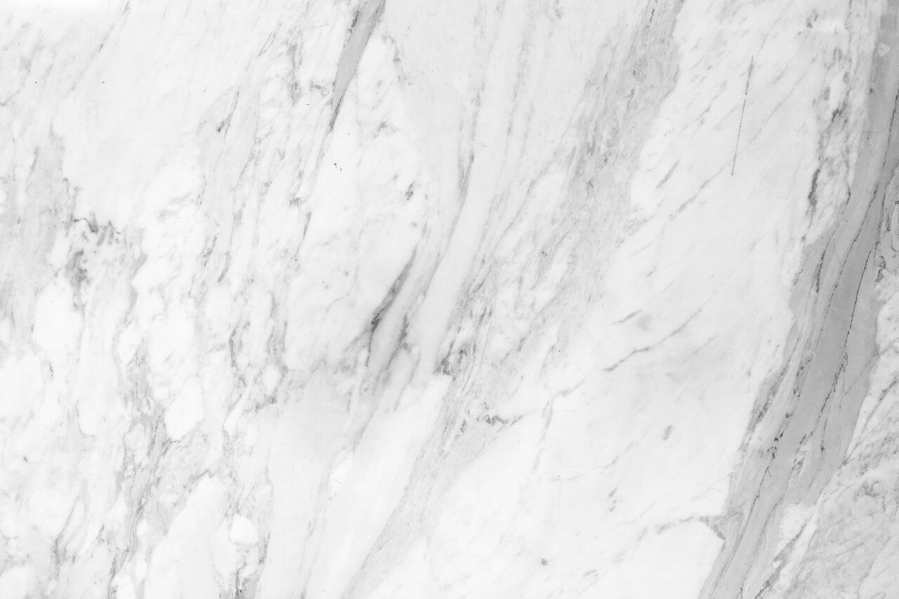 Close-up of a white marble surface showing natural veining patterns