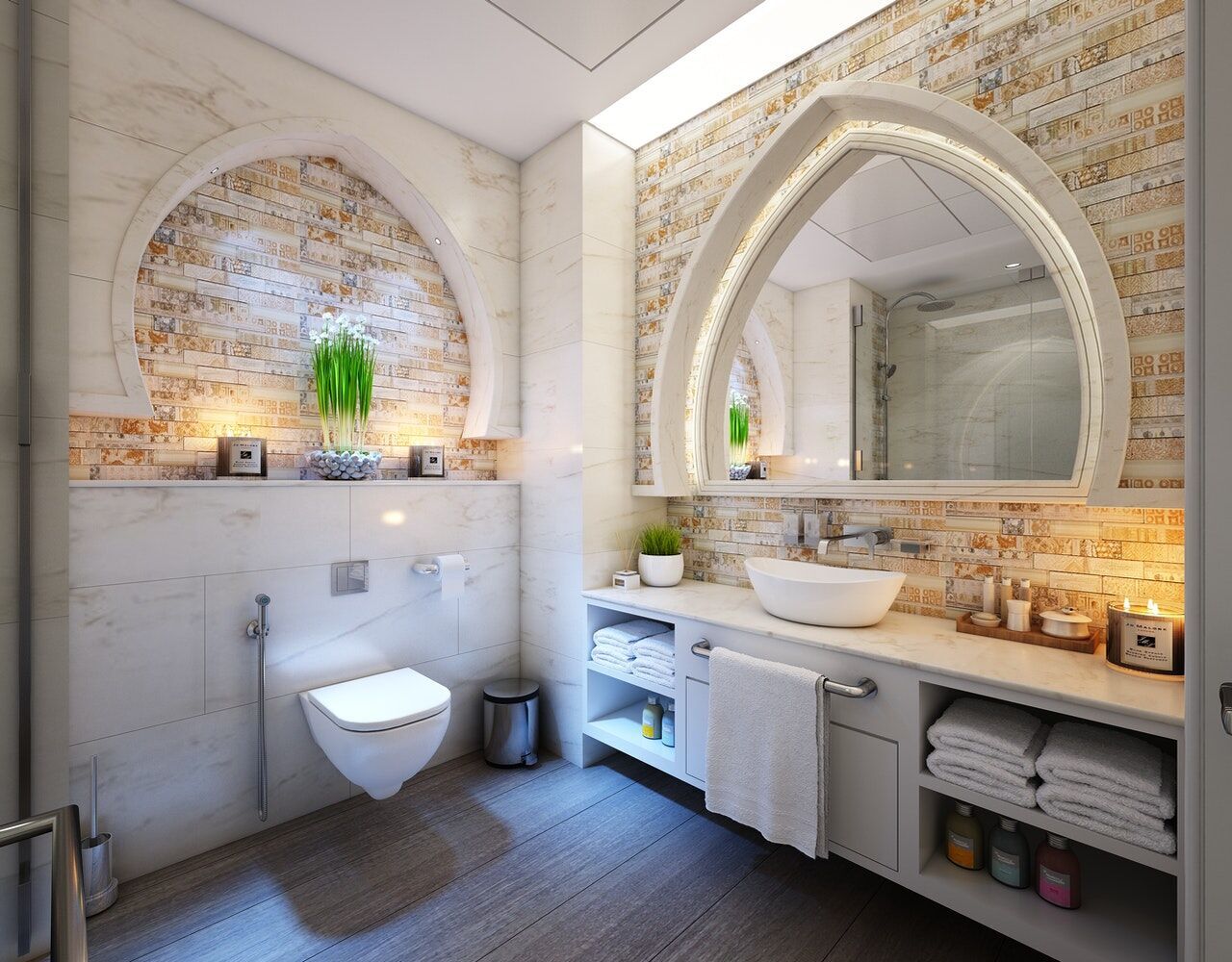 Modern bathroom with quartz countertop, vessel sink, and decorative mirror above a vanity