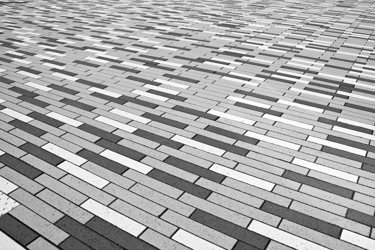 Black and white image of rectangular tiles arranged in a staggered pattern