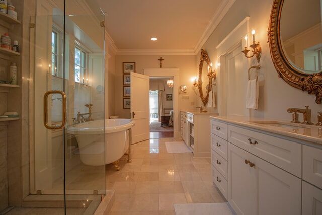Luxurious bathroom with marble floors, freestanding tub, and elegant fixtures