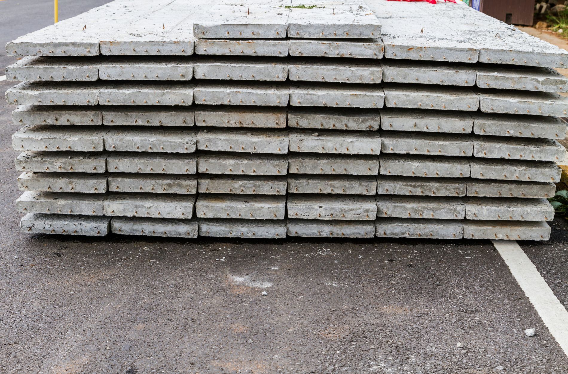 Stack of concrete slabs on outdoor surface prepared for installation