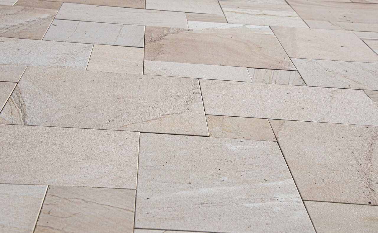 Close-up of beige stone tiles in a staggered pattern with natural textures and color variations